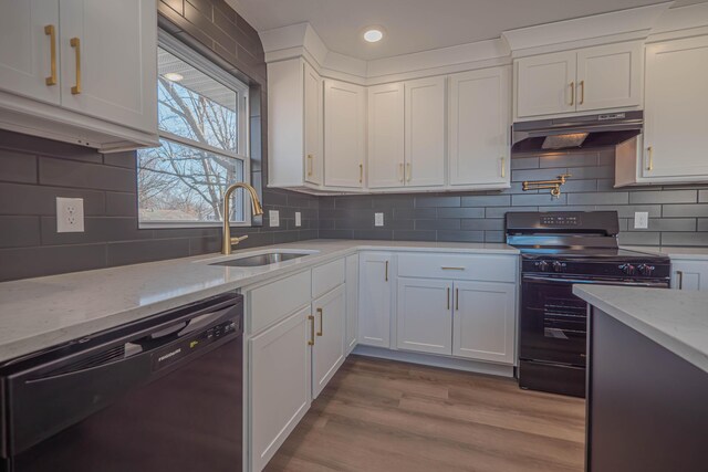 kitchen featuring black appliances, white cabinets, under cabinet range hood, and a sink