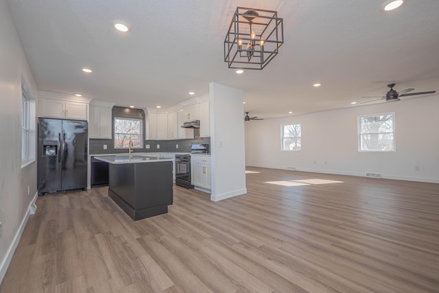 kitchen with white cabinetry, electric stove, open floor plan, and black refrigerator with ice dispenser