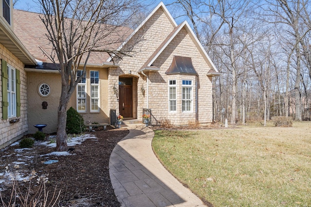 view of front of house with a shingled roof and a front yard