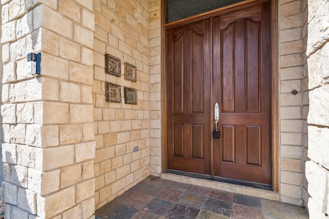 view of exterior entry with stone siding