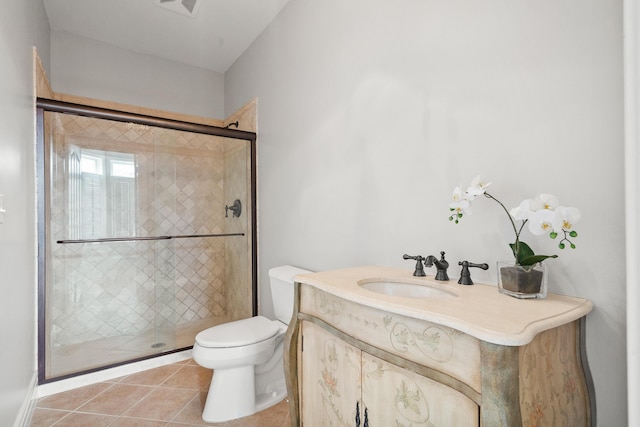 bathroom with toilet, a stall shower, tile patterned flooring, and vanity