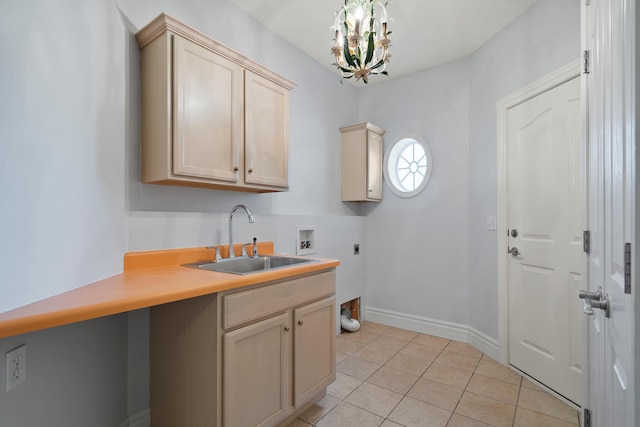 kitchen featuring a notable chandelier, light tile patterned floors, light countertops, a sink, and baseboards