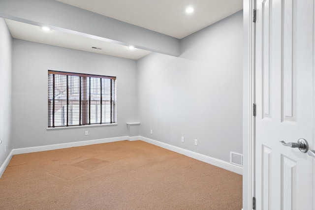 empty room featuring recessed lighting, light colored carpet, visible vents, and baseboards