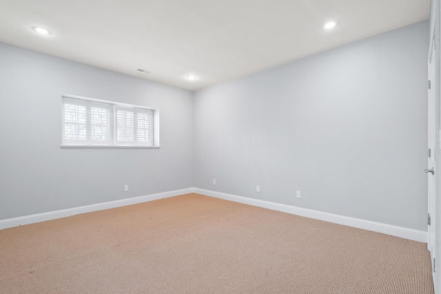 unfurnished room with recessed lighting, light carpet, and baseboards