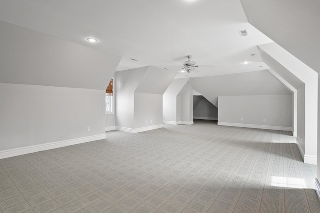 bonus room with carpet, visible vents, vaulted ceiling, ceiling fan, and baseboards