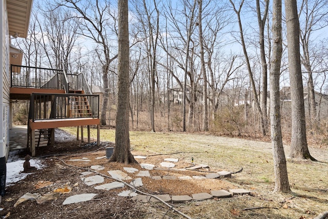 view of yard featuring stairs and a wooden deck