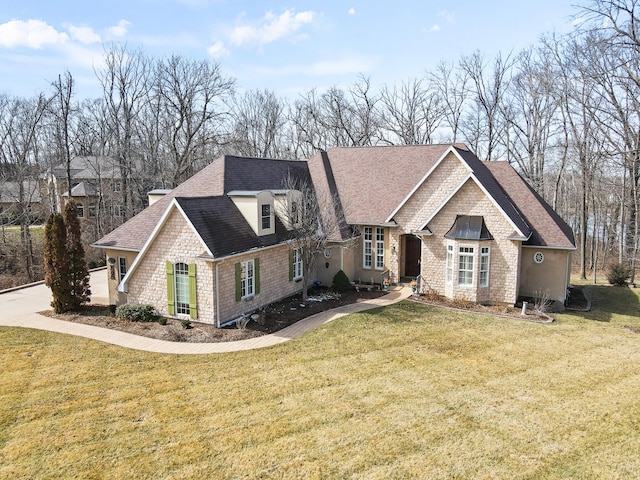 view of front of property featuring a shingled roof and a front yard