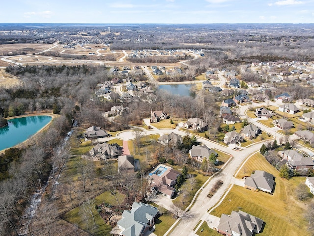 birds eye view of property with a water view and a residential view