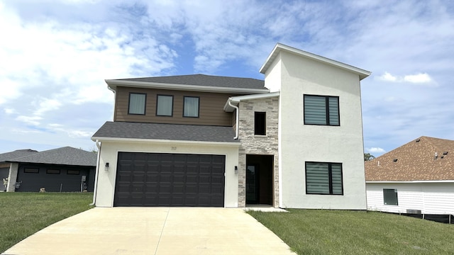 contemporary home with a garage and a front lawn