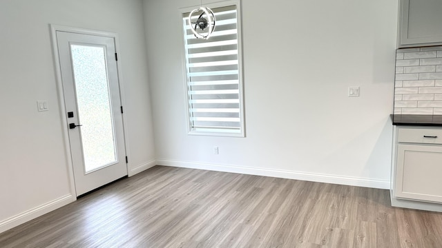 interior space with a wealth of natural light and light hardwood / wood-style flooring