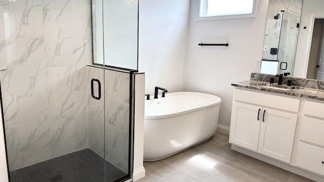 bathroom featuring tile patterned flooring, vanity, and separate shower and tub