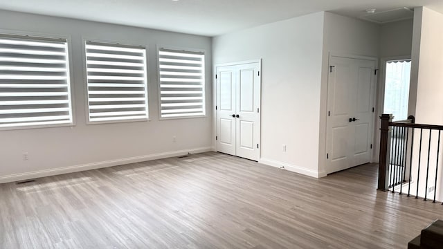 empty room with light hardwood / wood-style flooring