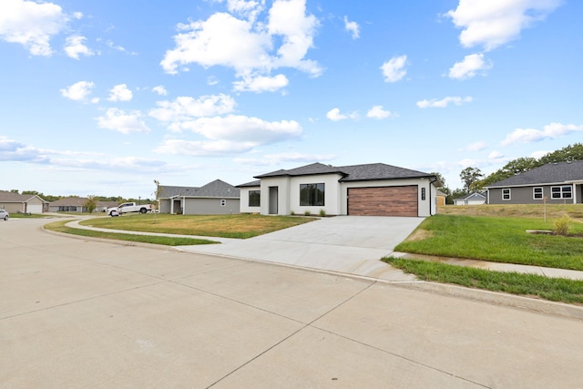 view of front of home with a garage and a front lawn