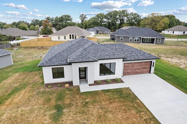 view of front of house with a garage and a front lawn