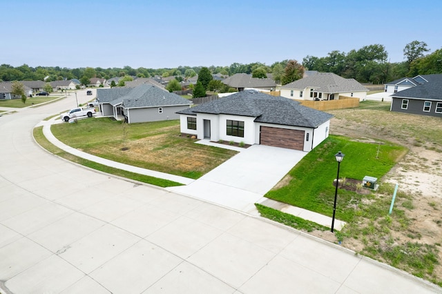 view of front facade featuring a front lawn and a garage