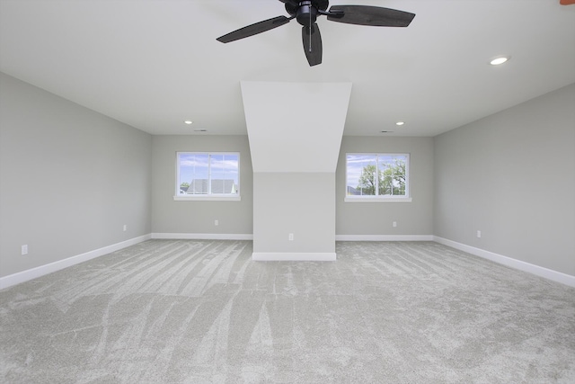 unfurnished living room featuring light carpet and ceiling fan