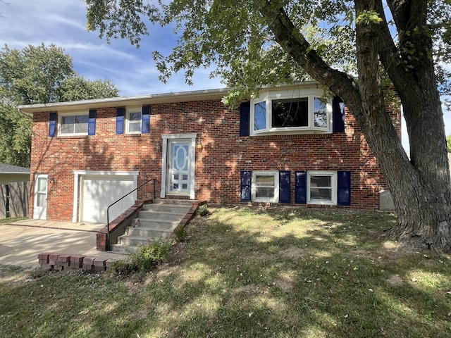 raised ranch with a garage and a front lawn