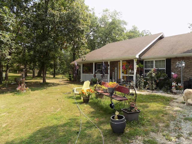 view of yard featuring covered porch