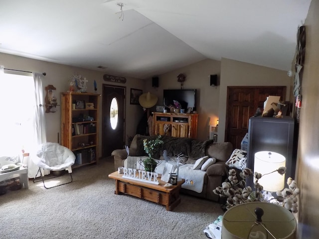 living room featuring carpet flooring and vaulted ceiling