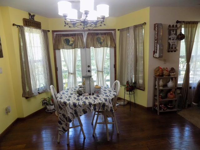 dining area featuring a chandelier, french doors, and dark wood-type flooring