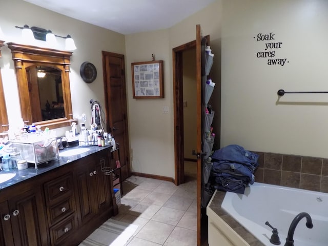 bathroom featuring vanity, tile patterned floors, and a tub