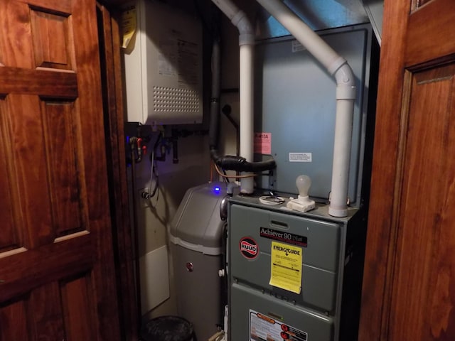 utility room featuring water heater