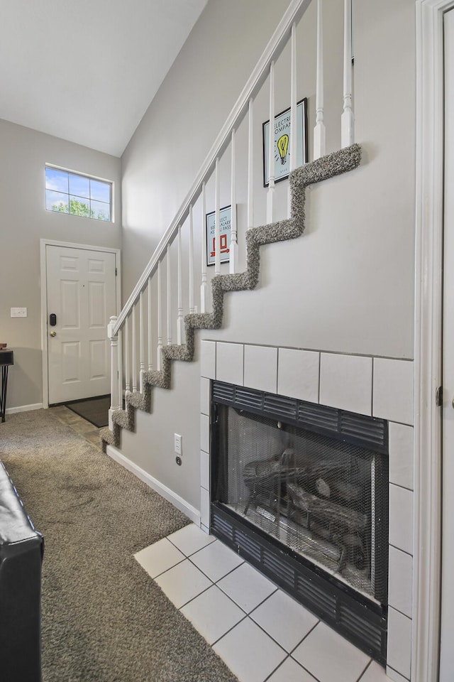 carpeted entryway with a fireplace