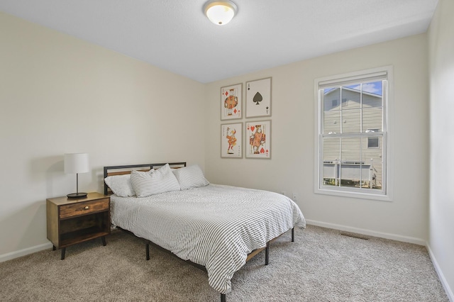 bedroom featuring light carpet