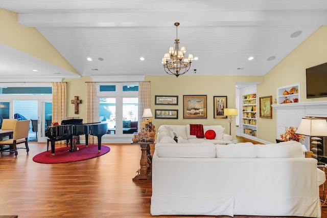 living room with vaulted ceiling with beams, built in features, wood-type flooring, and a chandelier