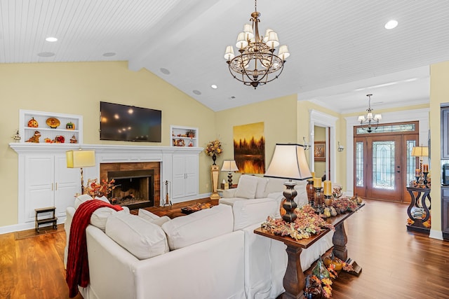 living room featuring vaulted ceiling with beams, light hardwood / wood-style floors, built in features, and wooden ceiling