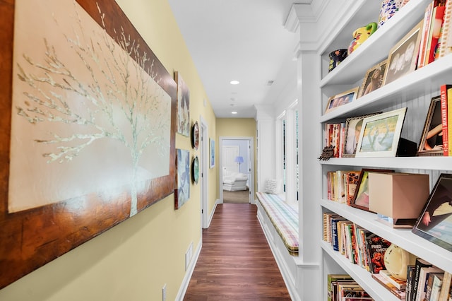 hallway with built in features and dark wood-type flooring