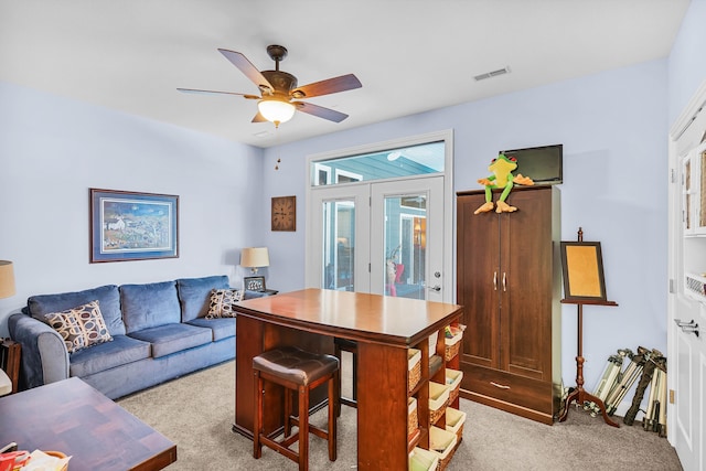 office space featuring french doors, light colored carpet, and ceiling fan