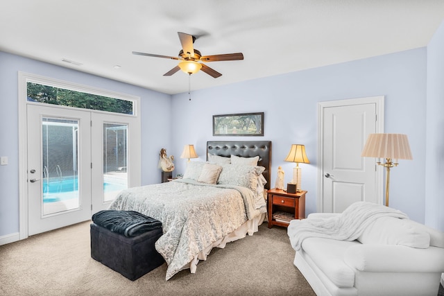 carpeted bedroom with ceiling fan, access to exterior, and multiple windows