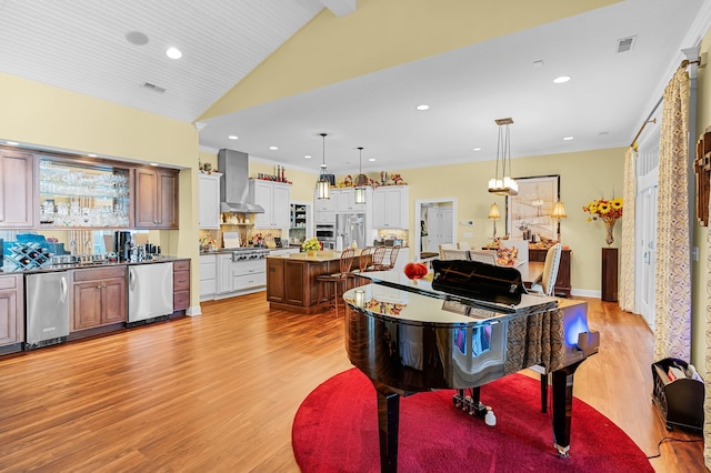 interior space featuring vaulted ceiling with beams, sink, and light hardwood / wood-style flooring