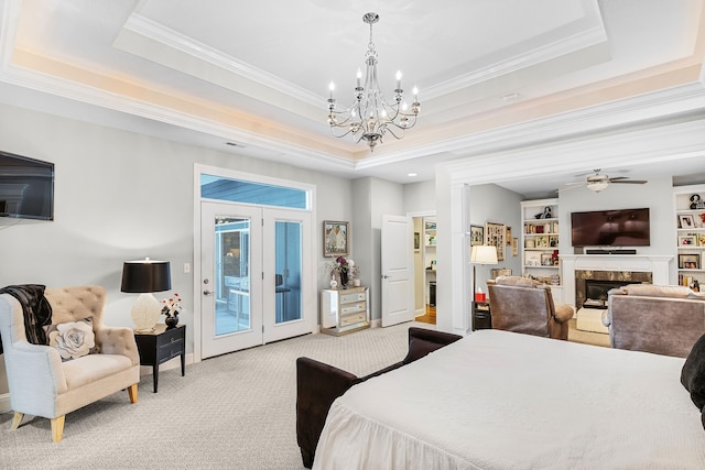 carpeted bedroom with an inviting chandelier, crown molding, access to outside, and a tray ceiling