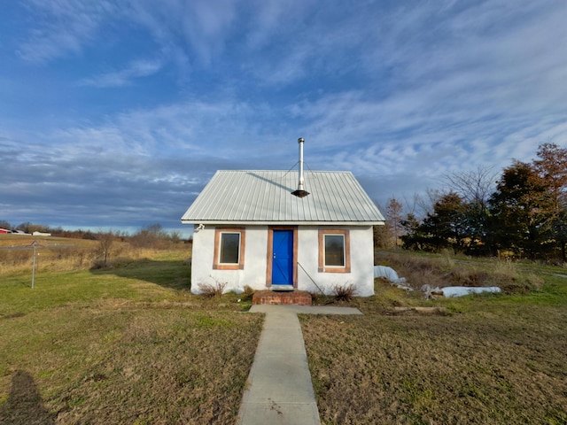 view of outbuilding with a lawn