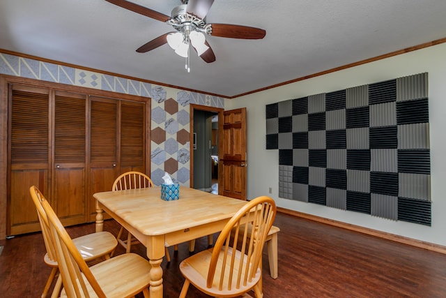 dining area featuring a textured ceiling, dark hardwood / wood-style flooring, ceiling fan, and crown molding