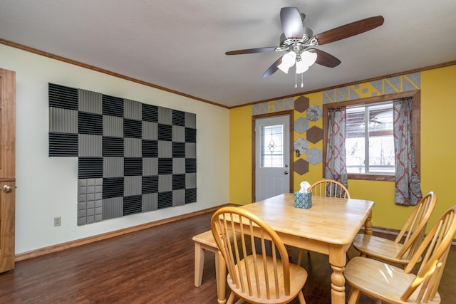 dining space with ceiling fan, ornamental molding, and dark wood-type flooring