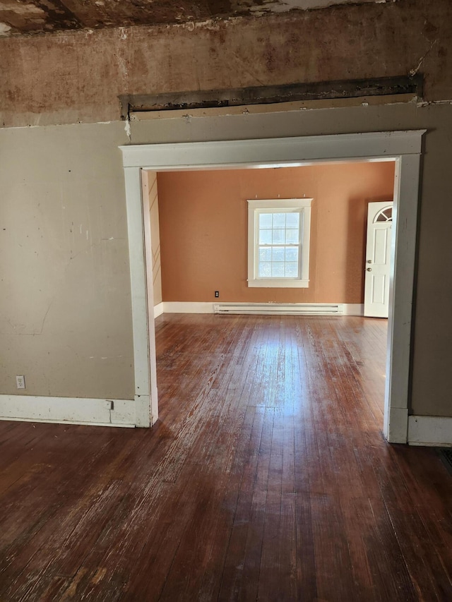 spare room with hardwood / wood-style floors and a baseboard radiator