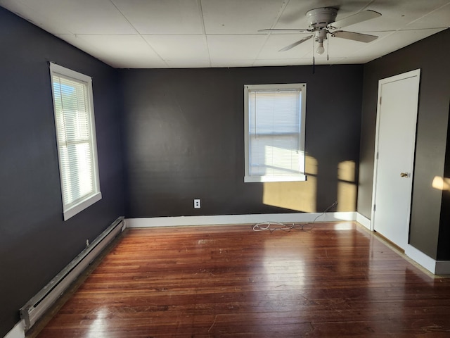 spare room with a baseboard radiator, dark hardwood / wood-style floors, and ceiling fan