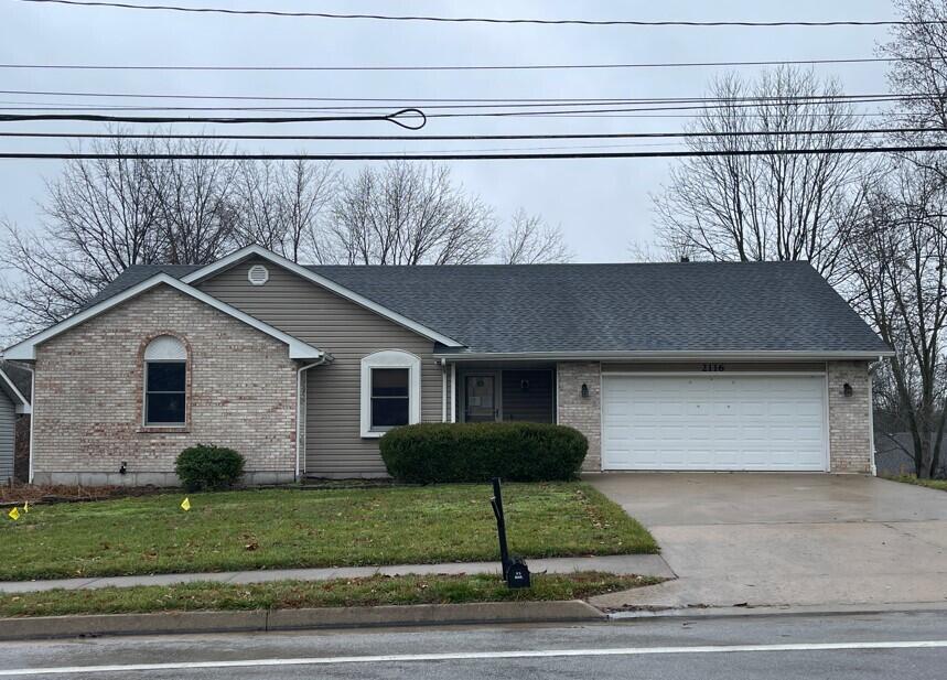 view of front of house with a garage and a front lawn