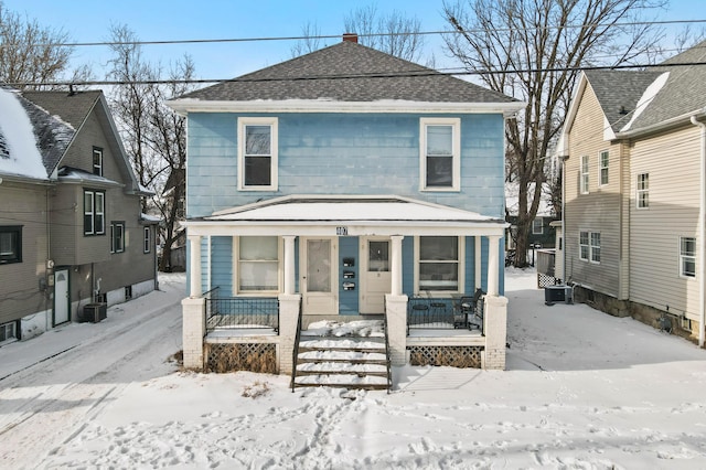 view of property with a porch and central AC unit