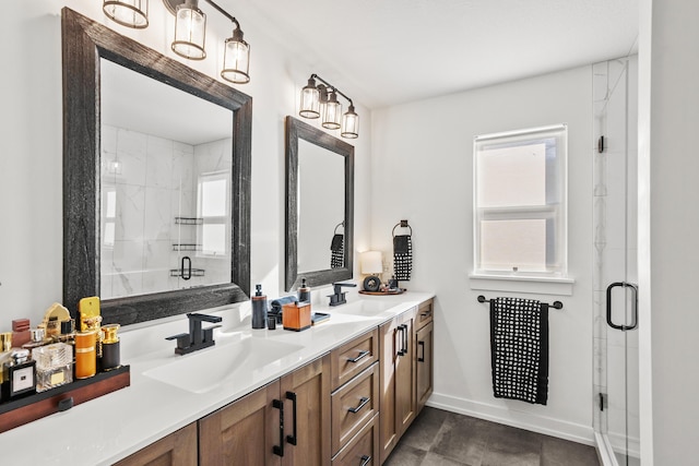 bathroom featuring a shower with shower door, a healthy amount of sunlight, and vanity