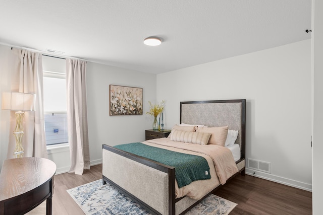 bedroom with hardwood / wood-style flooring