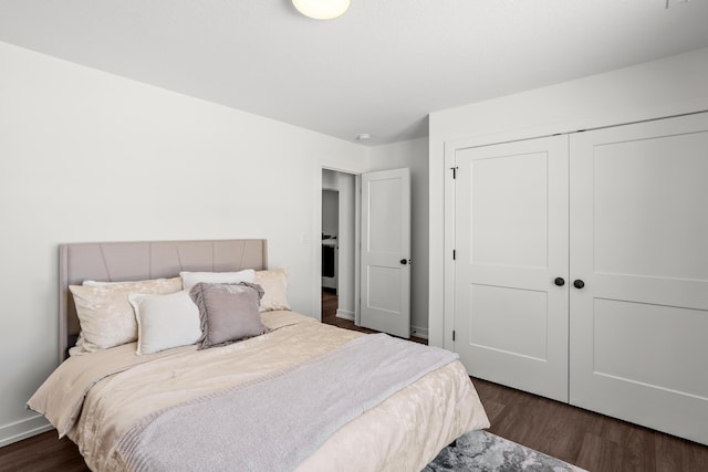 bedroom with dark hardwood / wood-style flooring and a closet