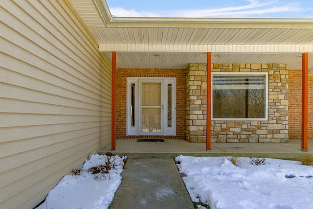 view of snow covered property entrance