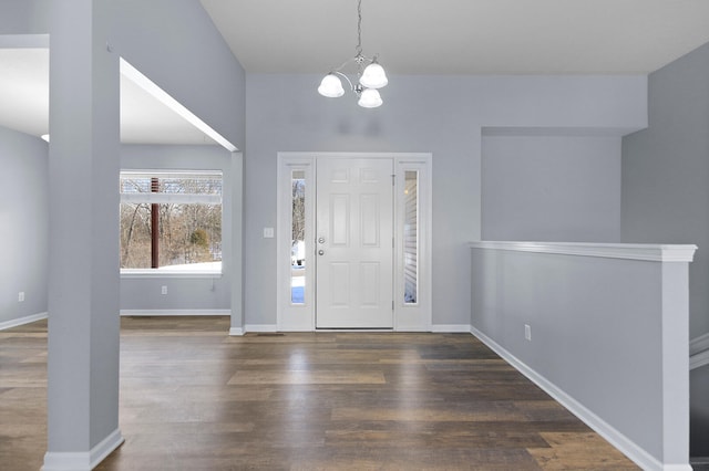 entrance foyer with dark wood-type flooring and an inviting chandelier