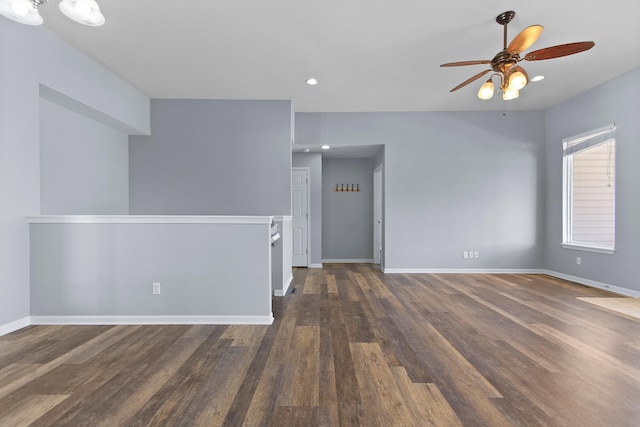 empty room with ceiling fan and dark wood-type flooring