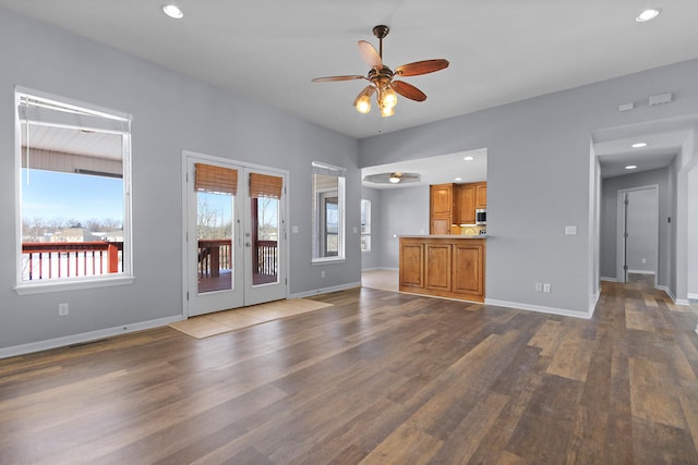 unfurnished living room with ceiling fan, french doors, and hardwood / wood-style flooring