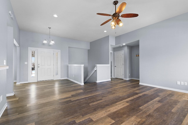 entryway with ceiling fan with notable chandelier and dark hardwood / wood-style flooring